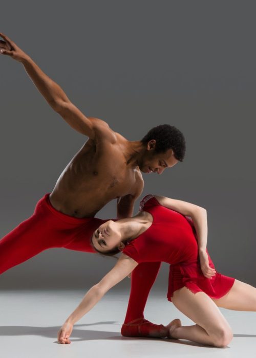 couple-of-ballet-dancers-posing-over-gray-background.jpg